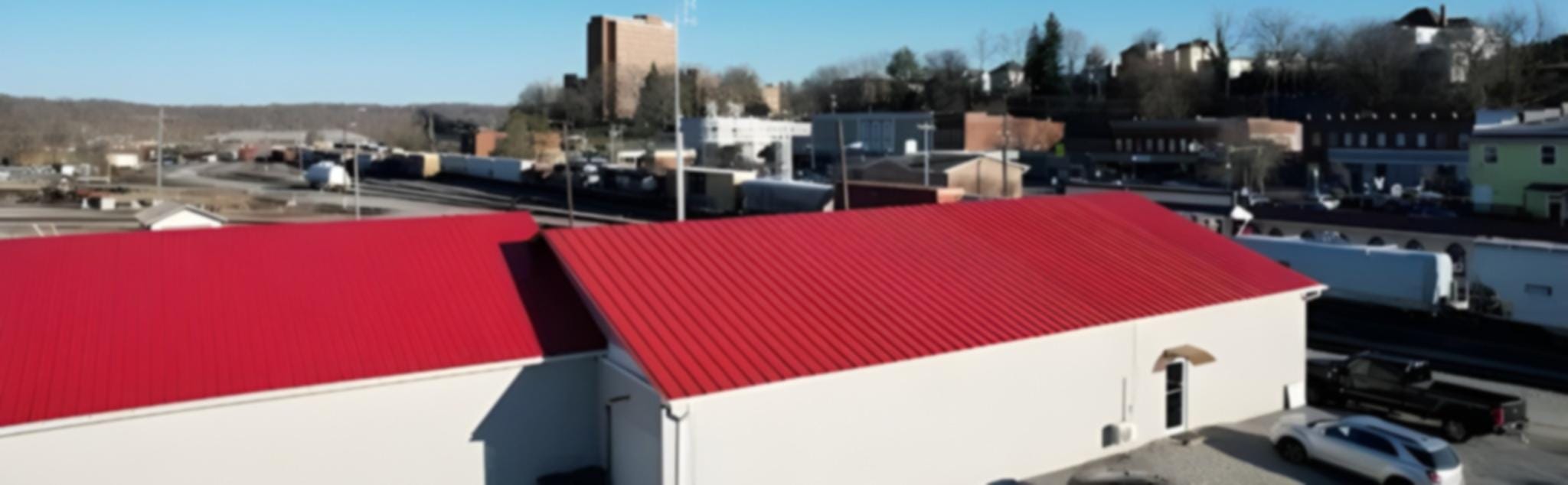 Red standing-seam metal roof on a commercial building
