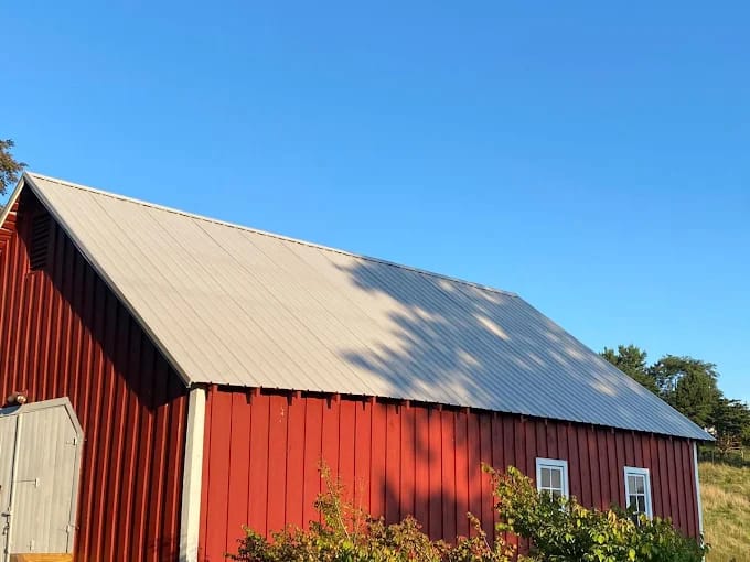 Red barn with a new metal roof