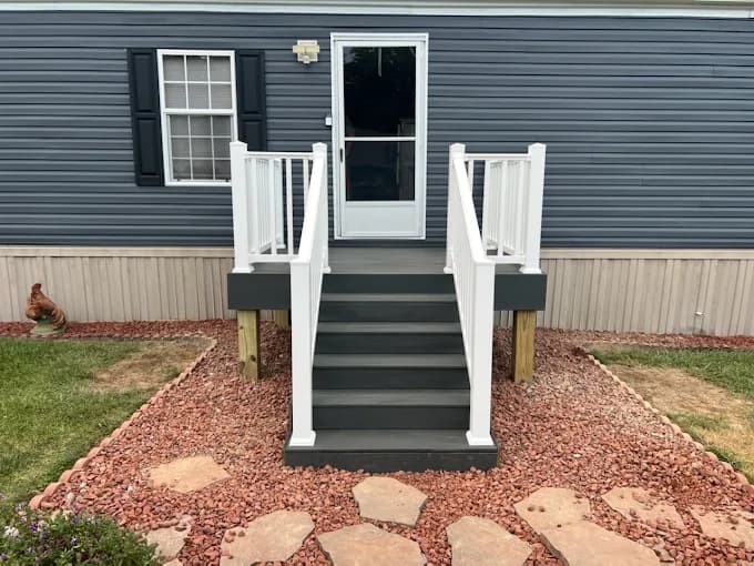 Gray composite deck and stairs on a mobile home