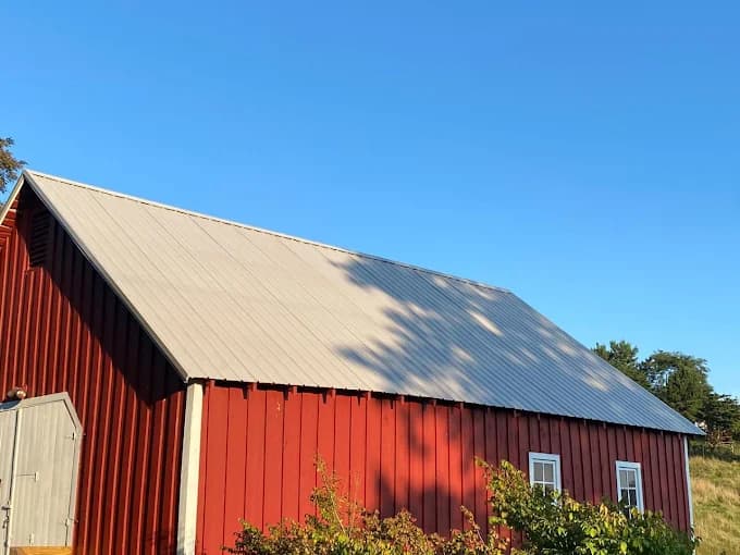 Red barn with a new metal roof