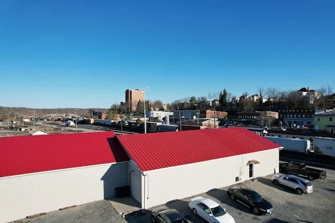 Red standing-seam metal roof on a commercial building