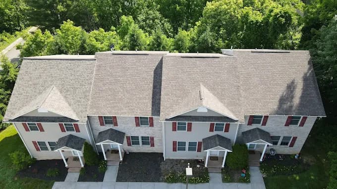 Aerial view of new roofs on a row of white townhouses